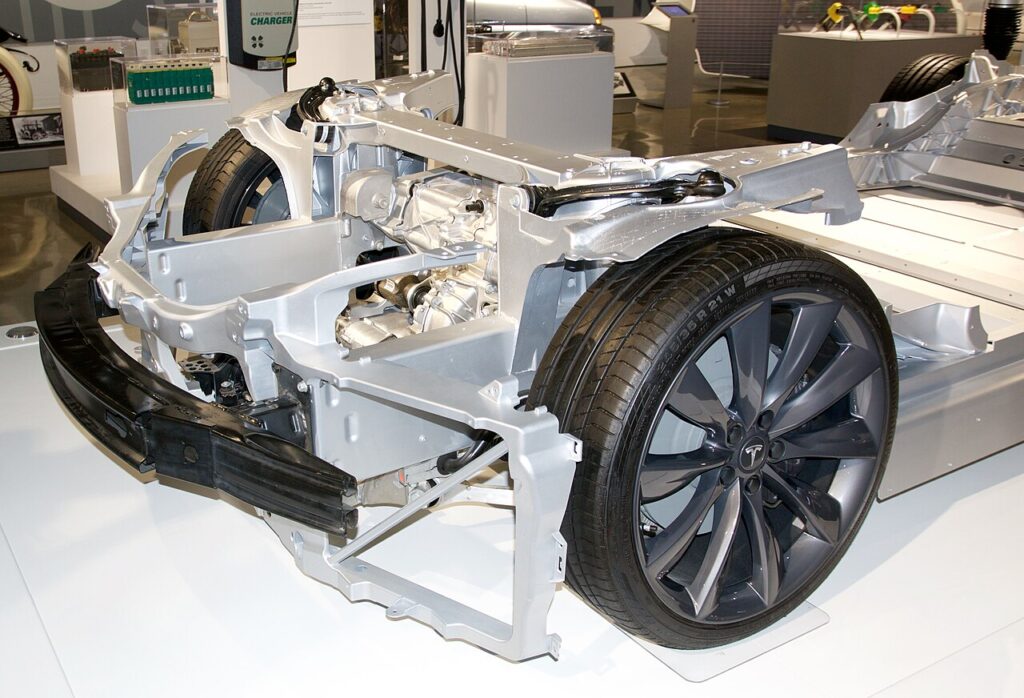 Front motor assembly and wheels on an exposed Tesla Model S chassis