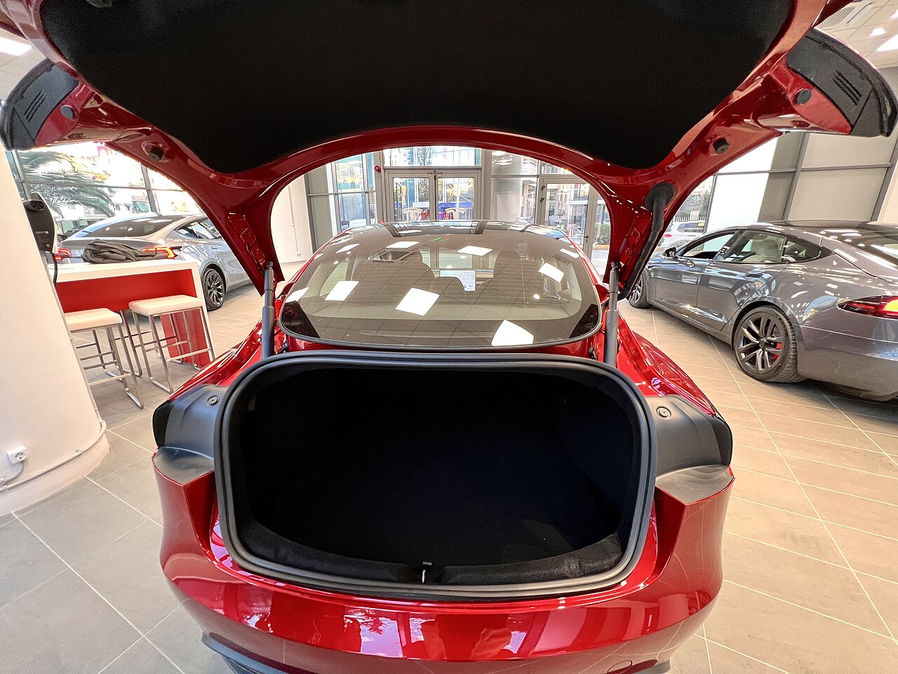 Open Tesla Model 3 rear trunk showing the lid, supports and luggage opening