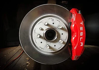 Brake disc and red caliper with the wheel removed
