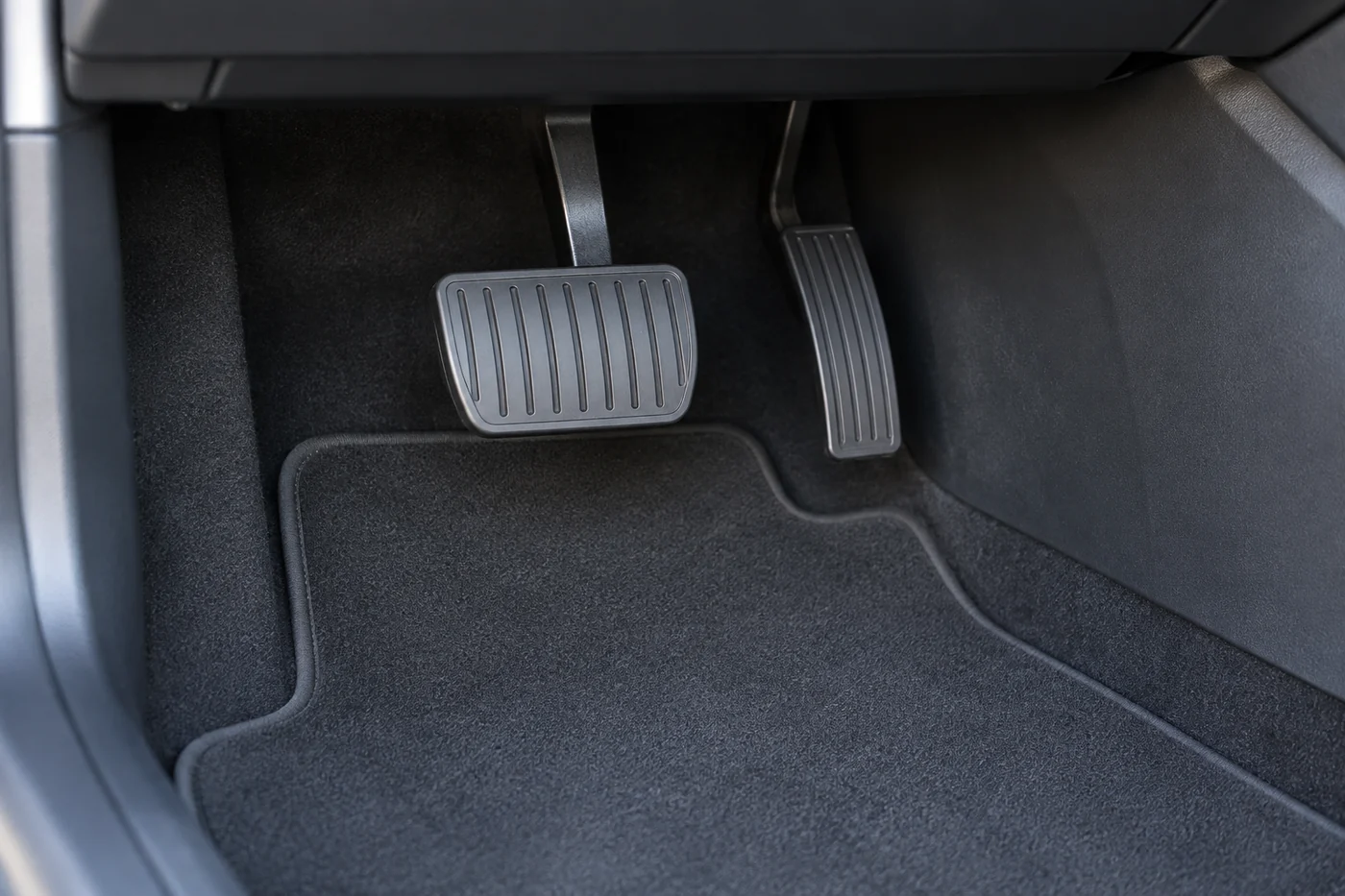 Brake and accelerator pedals in a Tesla driver's footwell