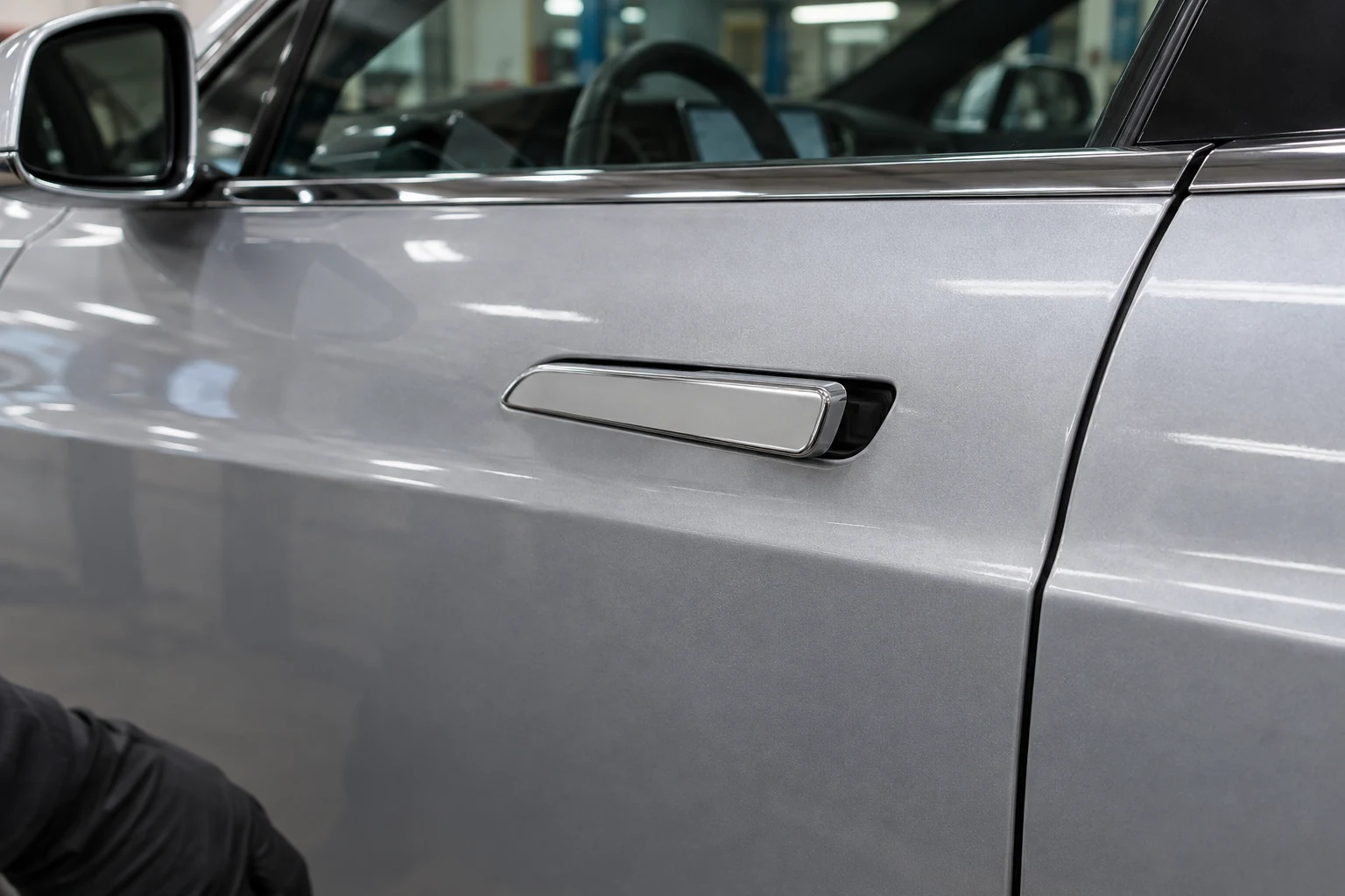 Extended chrome exterior door handle on a silver Tesla Model S