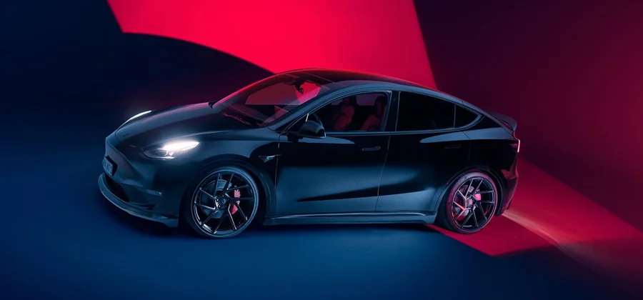 Dark Tesla Model Y viewed from the front and side